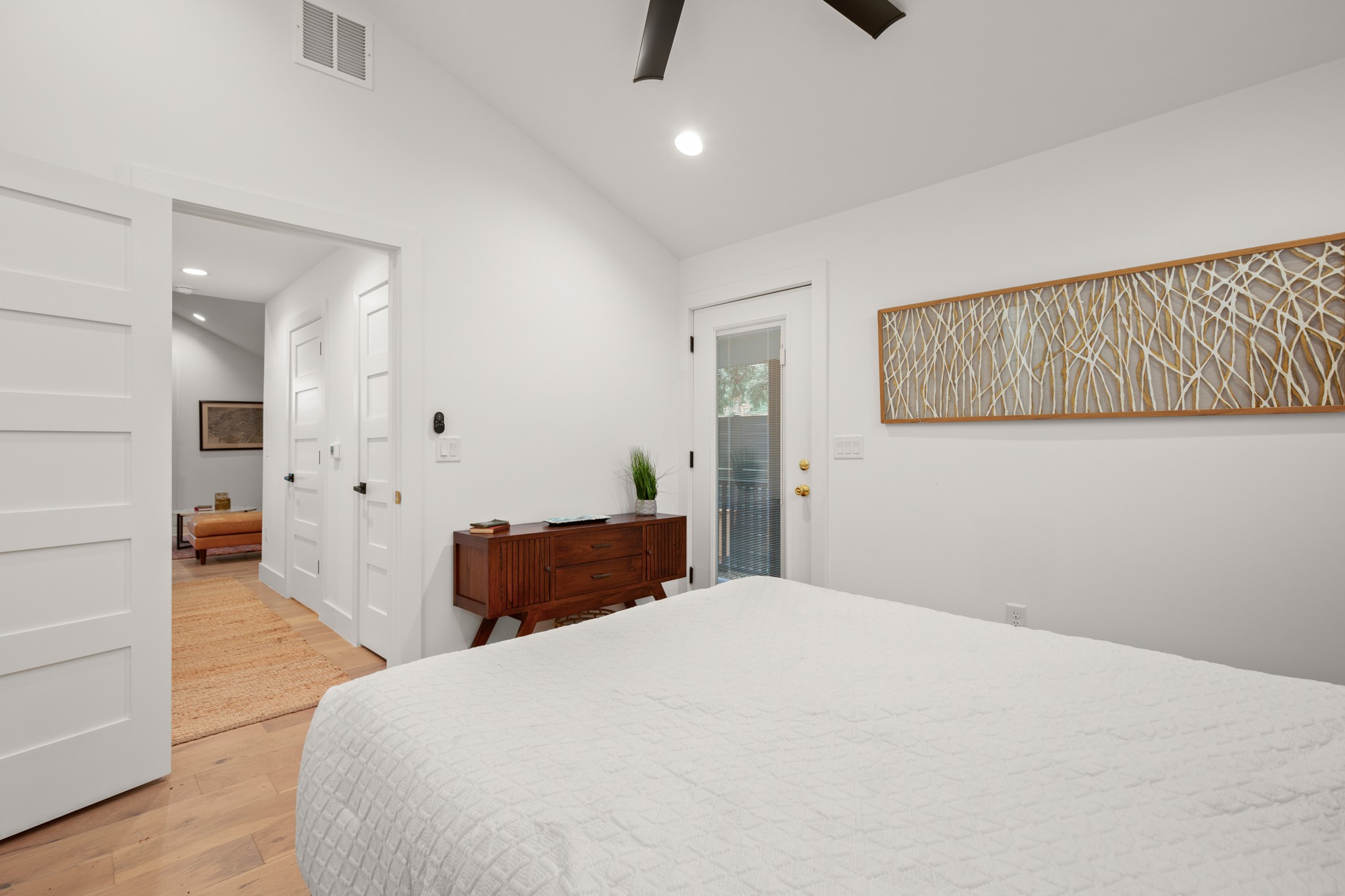 2416 East 10th Street Austin, TX 78702 - Photo 16 of 38 a bedroom with a bed and wooden floor