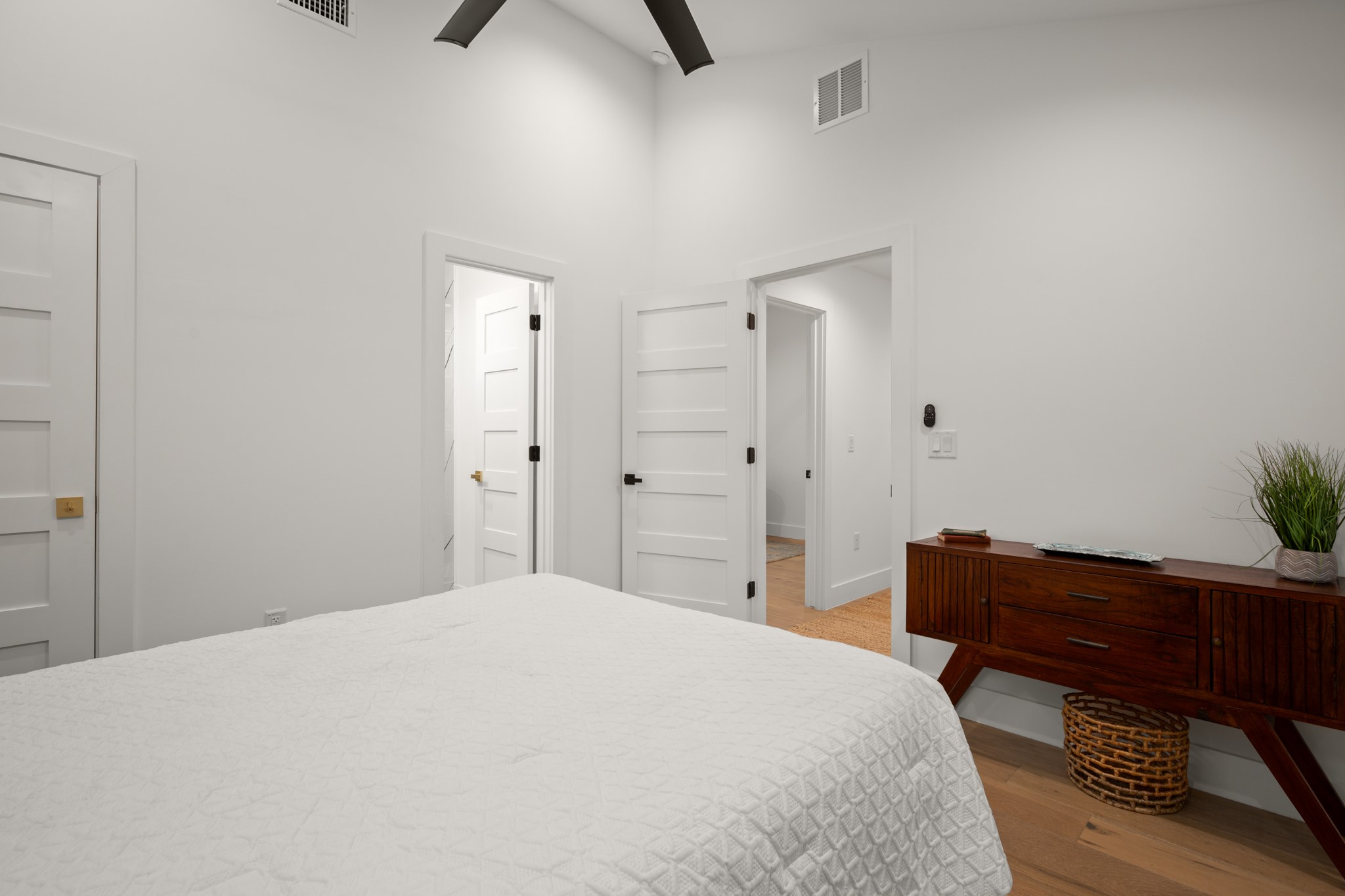 2416 East 10th Street Austin, TX 78702 - Photo 17 of 38 a bedroom with a bed and a potted plant