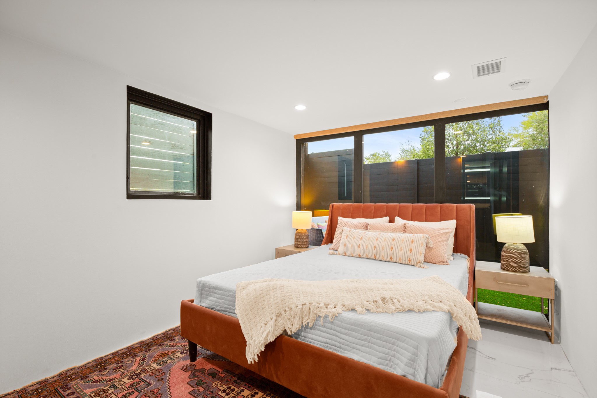 2416 East 10th Street Austin, TX 78702 - Photo 28 of 38 a bedroom with a large bed and a large window