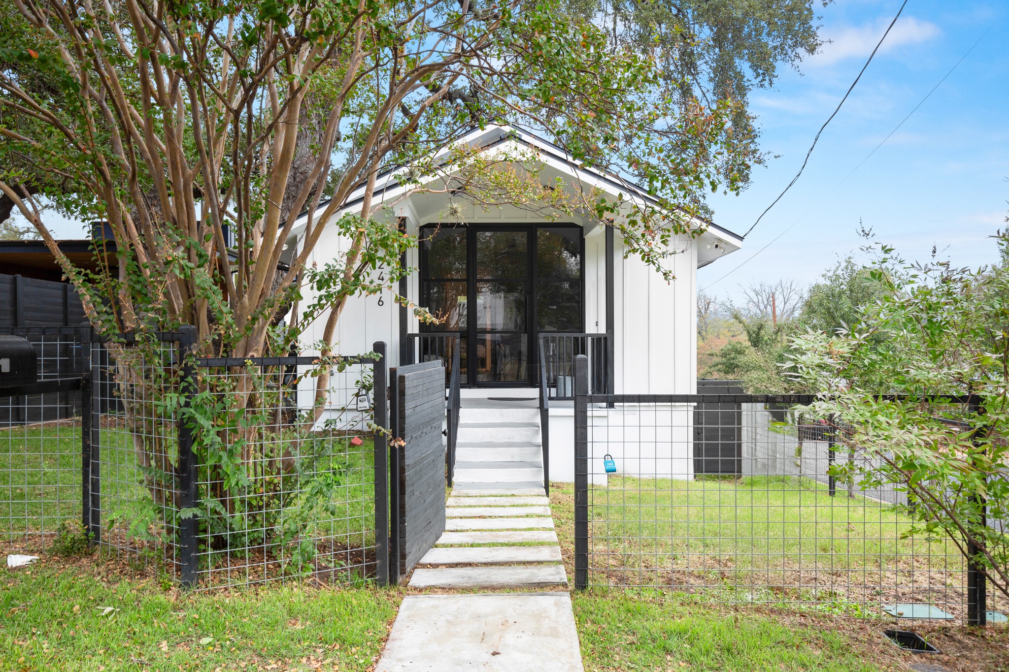 2416 East 10th Street Austin, TX 78702 - Photo 5 of 38 a front view of a house with a garden