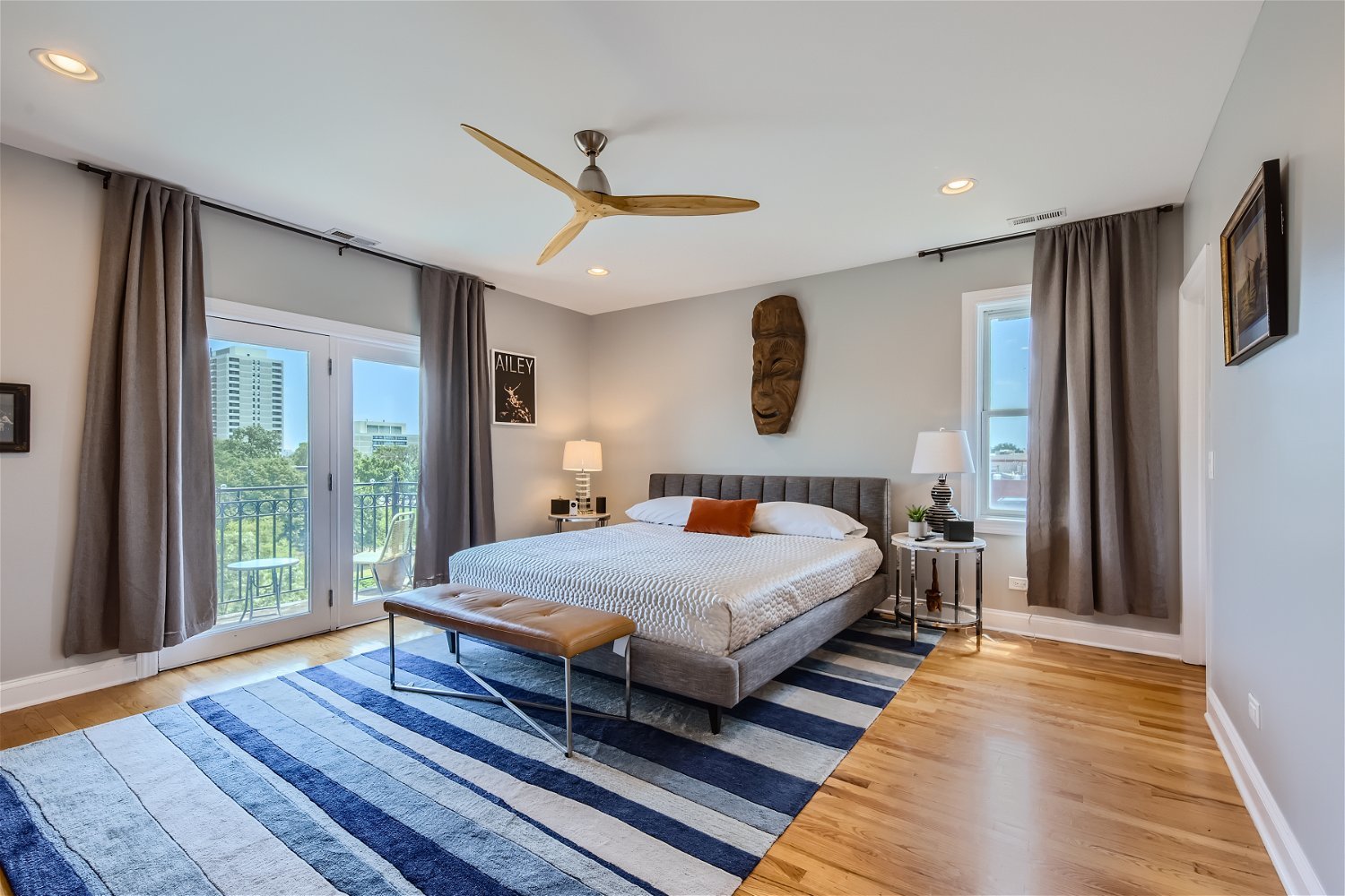 3719 South Indiana Avenue, Unit 4S Chicago, IL 60653 - Photo 10 of 17 a bedroom with a large bed and a large window