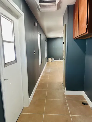 a bathroom with a granite countertop toilet sink and mirror