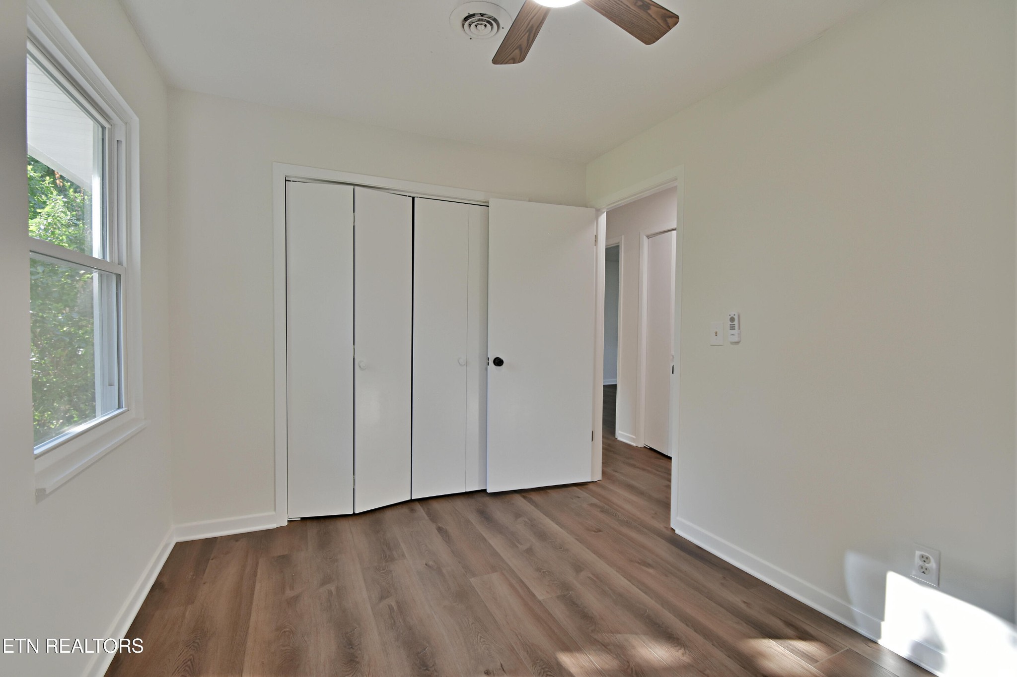 1119 Rudd Road Greenback, TN 37742 - Photo 12 of 28 a view of an empty room with wooden floor and a window