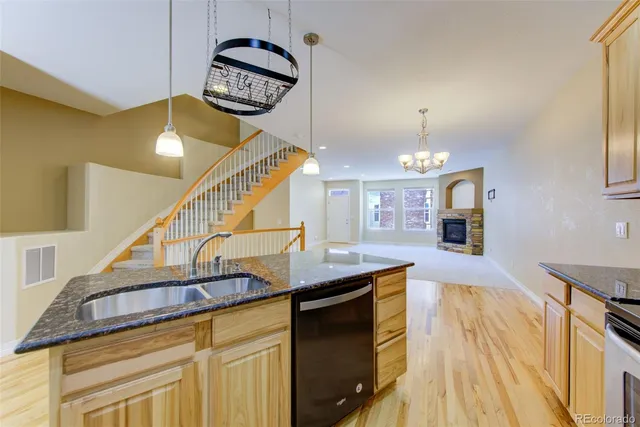 a view of a livingroom with furniture wooden floor and staircase