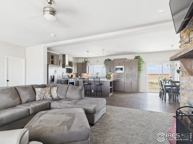 a living room with furniture and view of kitchen
