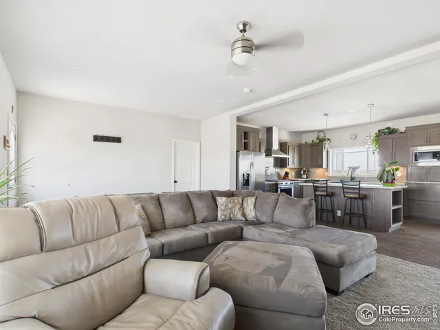 a living room with furniture kitchen view and a dining table