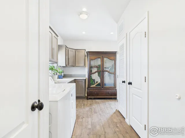 a hallway with cabinets and wooden floor