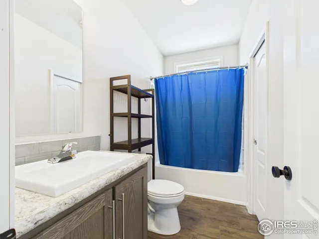 a bathroom with a sink vanity mirror and toilet