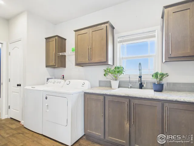 a utility room with cabinets washer and dryer