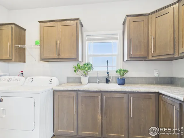 a kitchen with stainless steel appliances white cabinets and a window