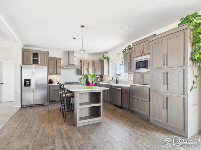 a kitchen with cabinets and stainless steel appliances