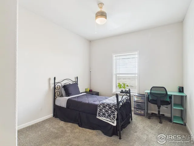 a bedroom with bed and a window