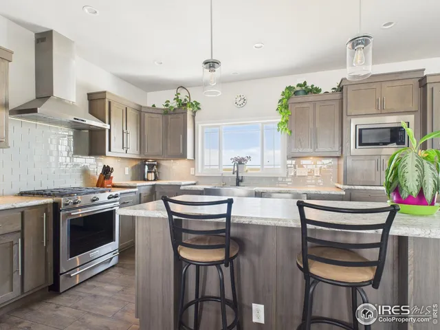 a kitchen with kitchen island a stove and a cabinets
