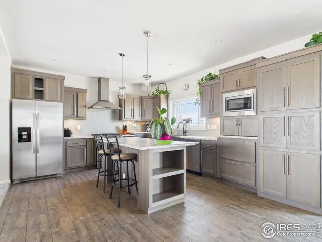 a kitchen with cabinets a sink and appliances
