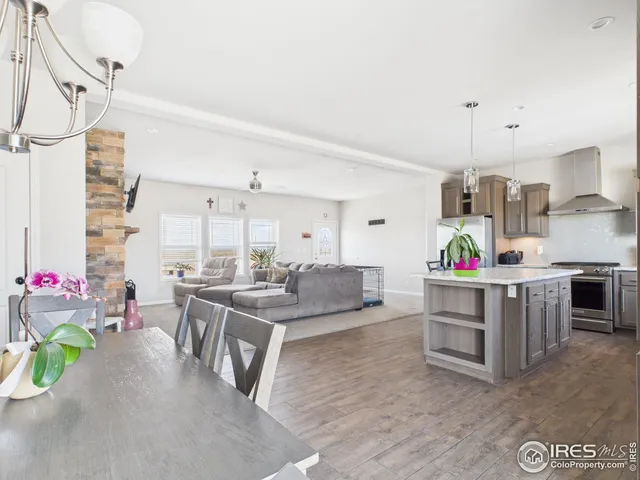 a living room with furniture and a kitchen view