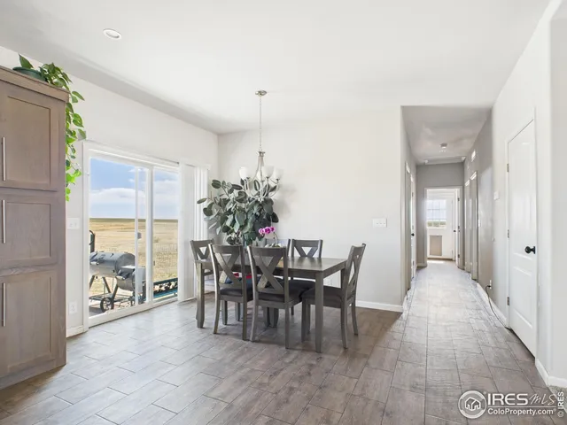 a view of a dining room with furniture and a potted plant