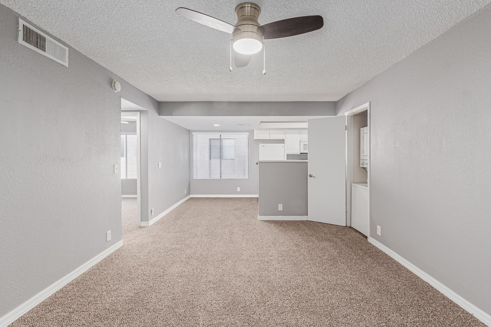 1077 West 1st Street, Unit 203 Tempe, AZ 85281 - Photo 18 of 22 an empty room with closet and windows