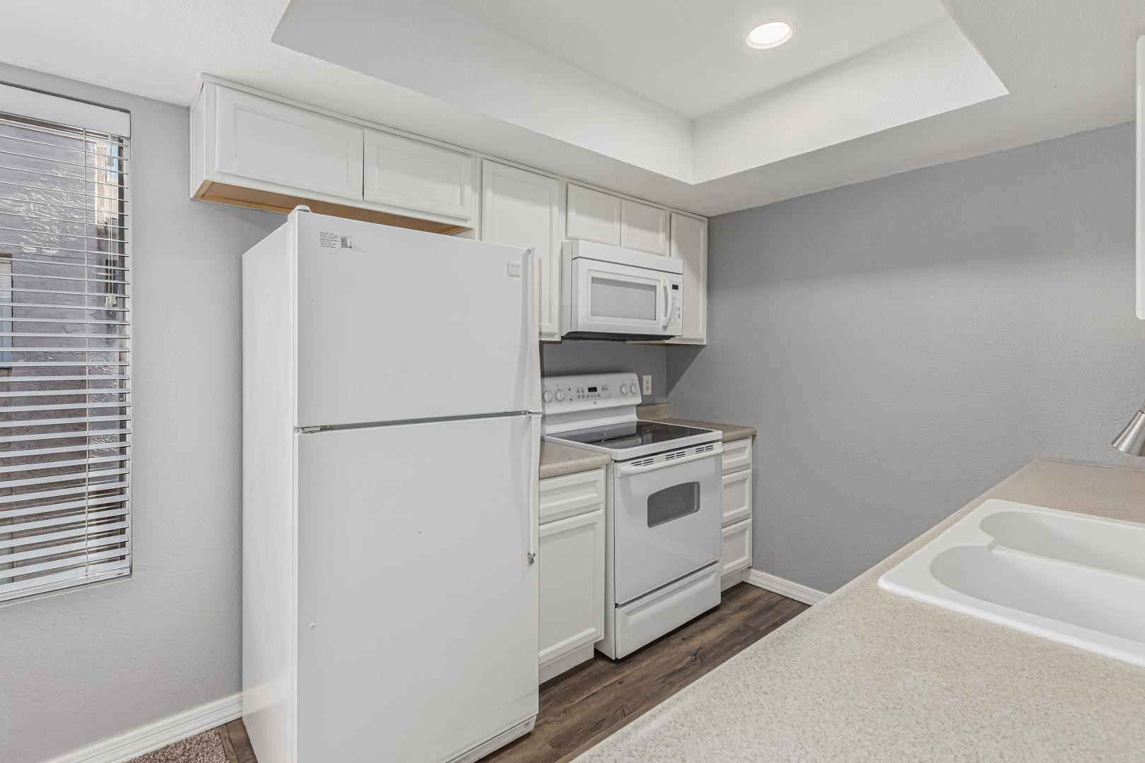 1077 West 1st Street, Unit 203 Tempe, AZ 85281 - Photo 9 of 22 a kitchen with stainless steel appliances a refrigerator a stove and white cabinets