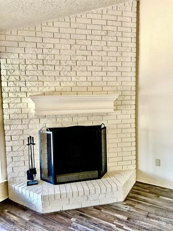 a living room with a fireplace and a fireplace