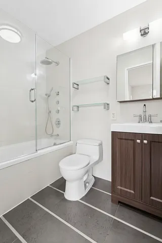 a bathroom with a sink toilet and mirror