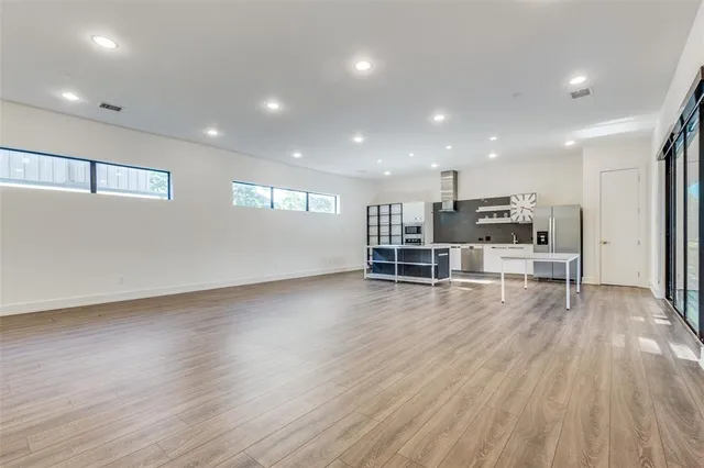 a view of kitchen with wooden floor and chairs