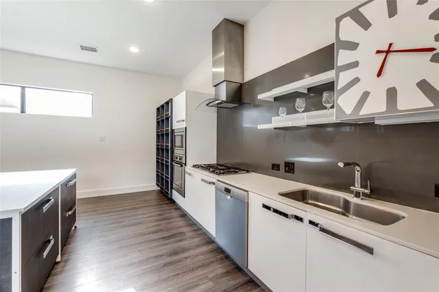 a kitchen with stainless steel appliances a sink and a stove