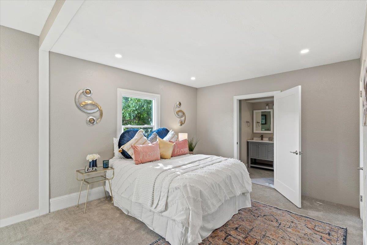 1306 Channing Way Berkeley, CA 94702 - Photo 12 of 42 a bedroom with a large bed and a chandelier