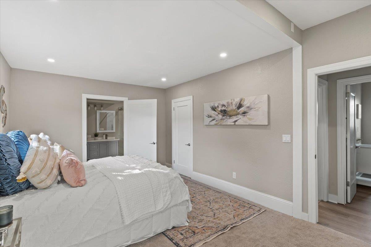 1306 Channing Way Berkeley, CA 94702 - Photo 13 of 42 a bedroom with a large bed and a chandelier