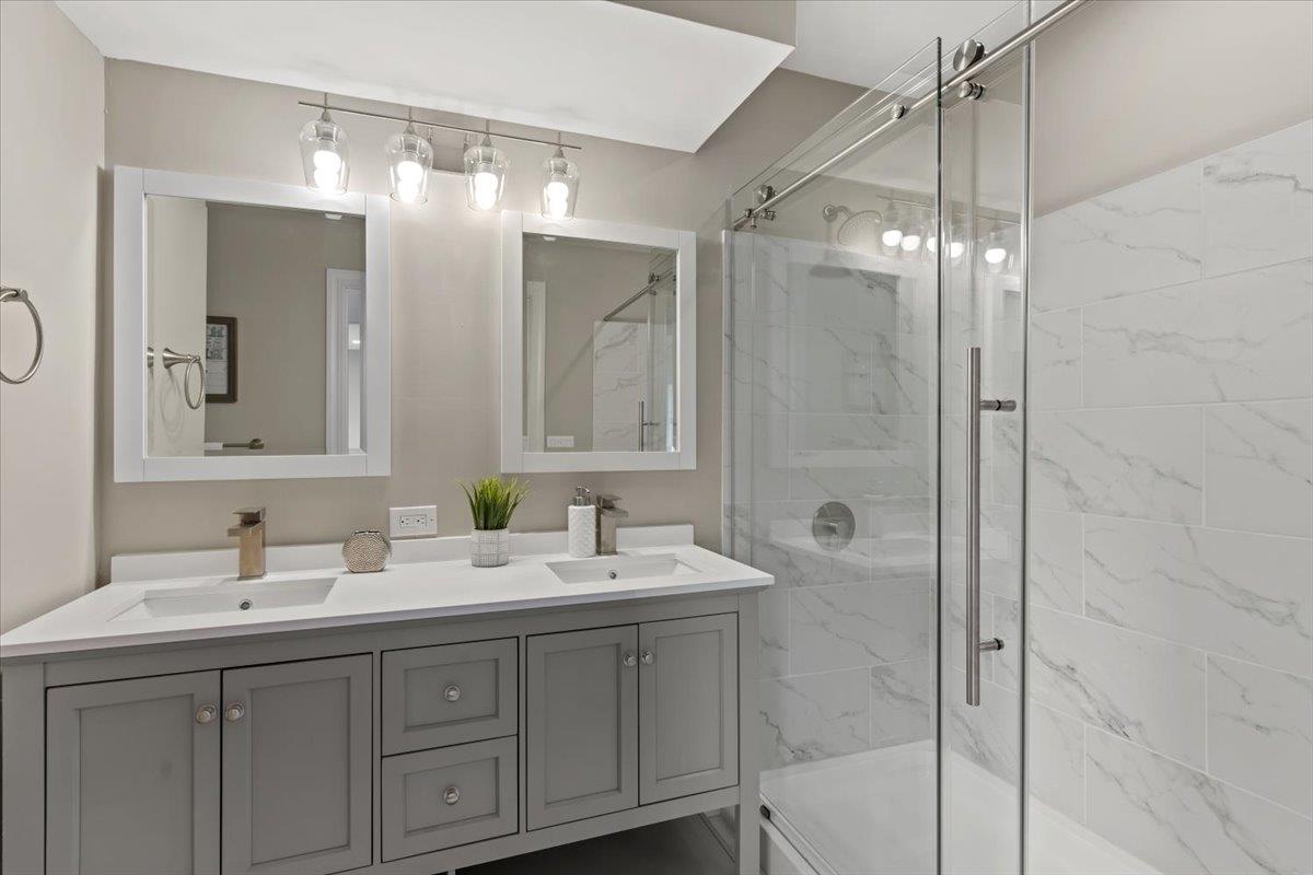 1306 Channing Way Berkeley, CA 94702 - Photo 15 of 42 a bathroom with a double vanity sink mirror and shower