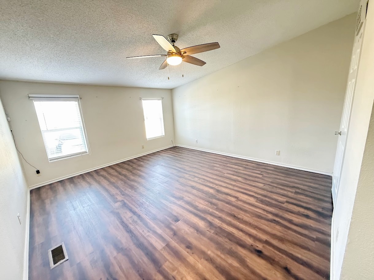 2709 County Road 463 Elgin, TX 78621 - Photo 17 of 25 wooden floor in an empty room with a window