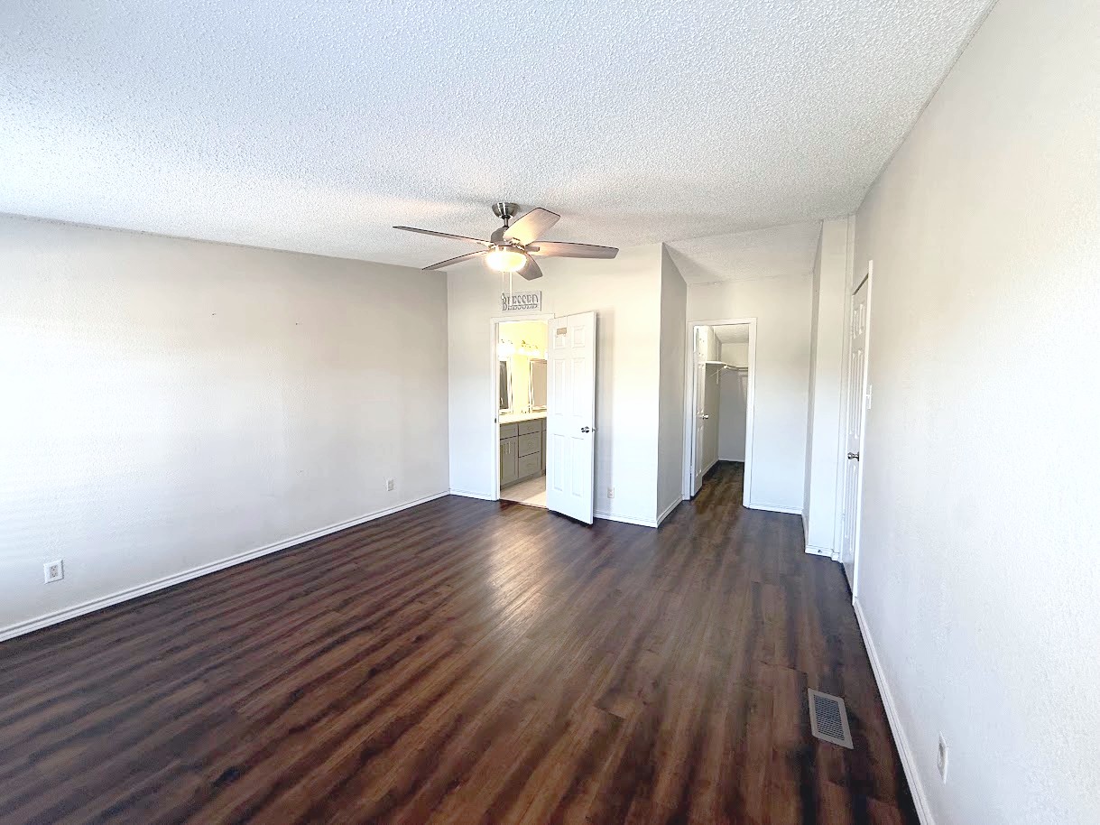 2709 County Road 463 Elgin, TX 78621 - Photo 18 of 25 a view of an empty room with wooden floor and a window