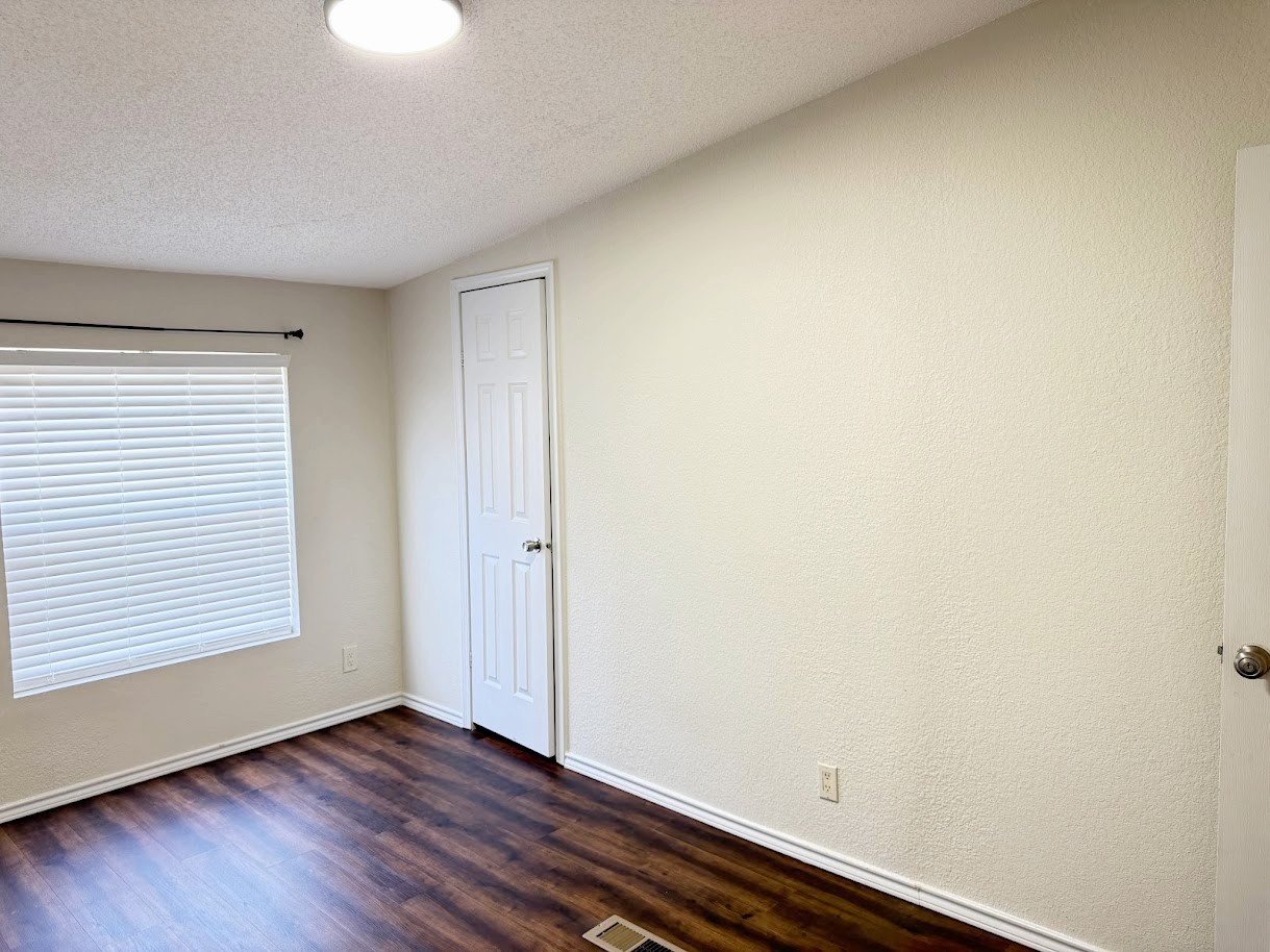 2709 County Road 463 Elgin, TX 78621 - Photo 21 of 25 an empty room with wooden floor and windows