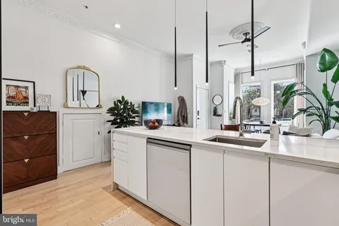 a kitchen with cabinets a sink and appliances