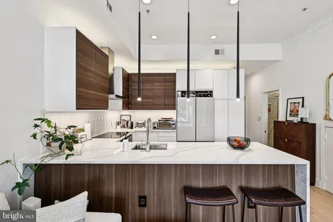 a kitchen with a table chairs sink and wooden floor
