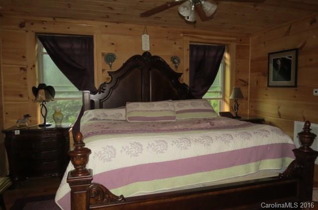 7275 Poors Ford Road Rutherfordton, NC 28139 - Photo 14 of 24 a bedroom with a bed and a chandelier