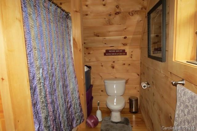 7275 Poors Ford Road Rutherfordton, NC 28139 - Photo 16 of 24 a white toilet sitting next to a shower curtain
