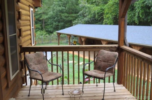 7275 Poors Ford Road Rutherfordton, NC 28139 - Photo 19 of 24 a view of a deck with table and chairs with wooden floor and fence