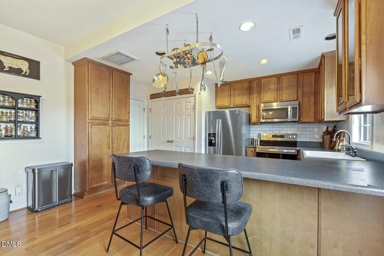 2131 Piney Brook Road, Unit 102 Raleigh, NC 27614 - Photo 10 of 23 a kitchen with stainless steel appliances granite countertop a stove refrigerator sink and cabinets
