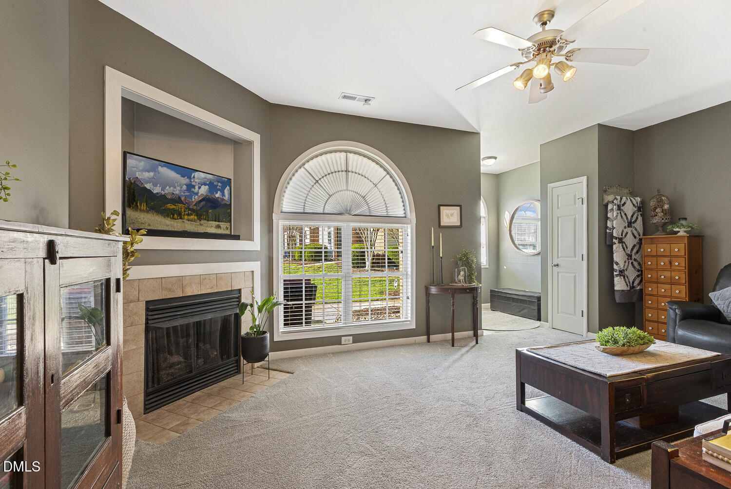 2131 Piney Brook Road, Unit 102 Raleigh, NC 27614 - Photo 6 of 23 a living room with furniture a fireplace and a flat screen tv
