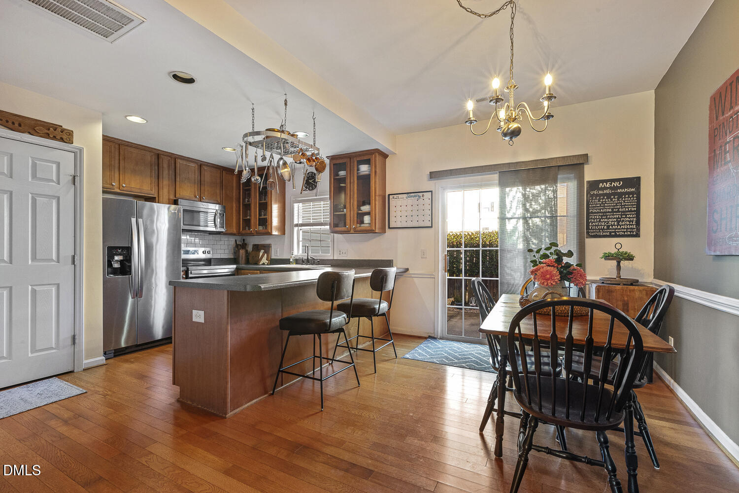 2131 Piney Brook Road, Unit 102 Raleigh, NC 27614 - Photo 8 of 23 a view of a dining room with furniture wooden floor and chandelier