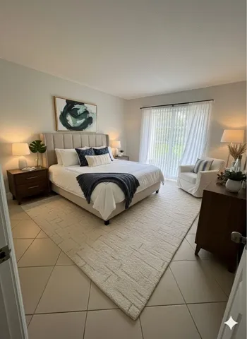 a spacious bedroom with a bed and window