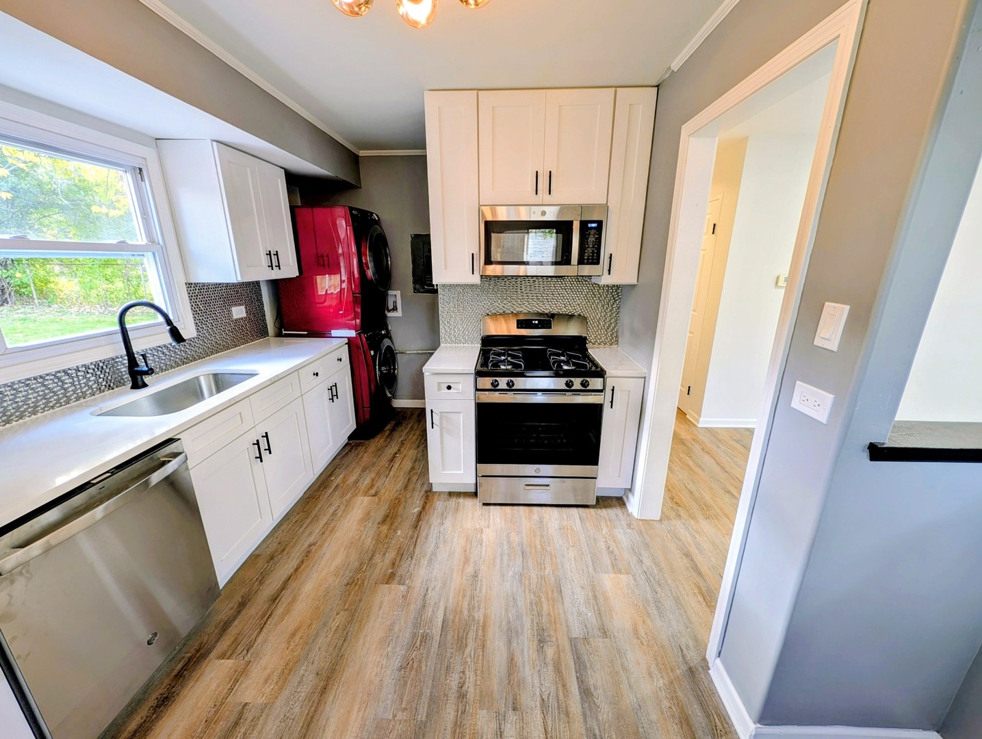 267 Arrowhead Street Park Forest, IL 60466 - Photo 3 of 12 a kitchen with stainless steel appliances a stove a sink a refrigerator a window and wooden floor