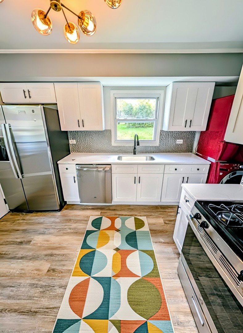 267 Arrowhead Street Park Forest, IL 60466 - Photo 4 of 12 a kitchen with a stove and wooden floor