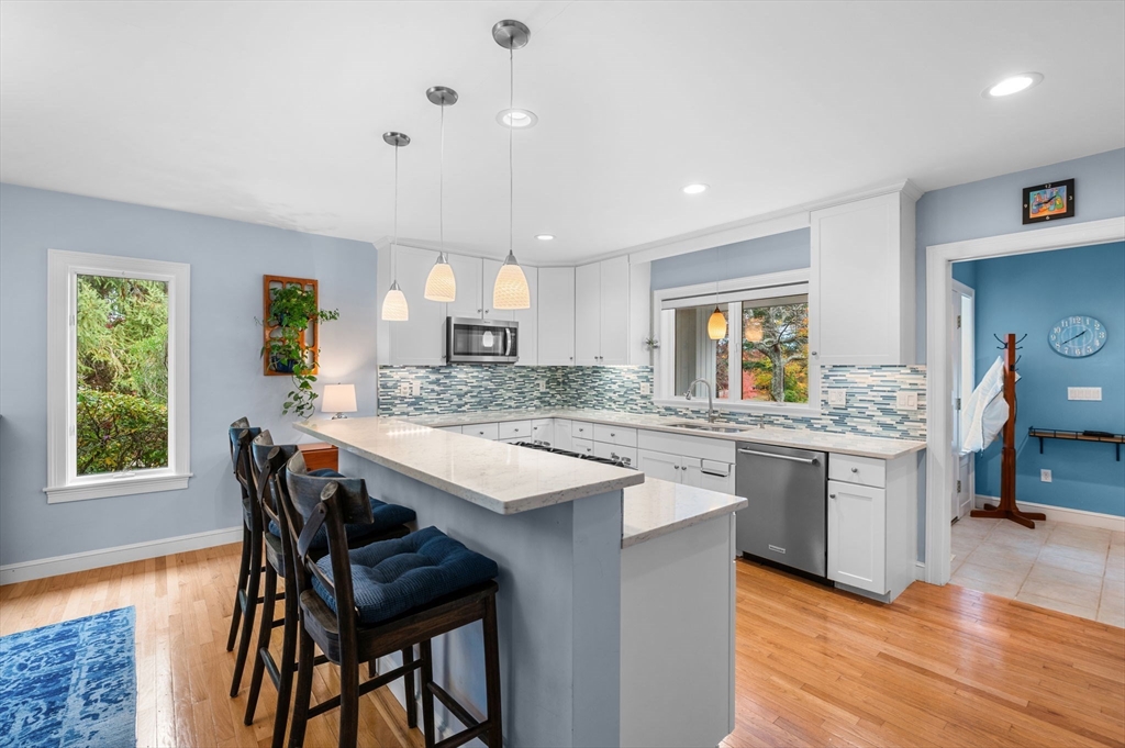 1 Court Lane Ipswich, MA 01938 - Photo 15 of 40 a kitchen with granite countertop kitchen island cabinets and wooden floor