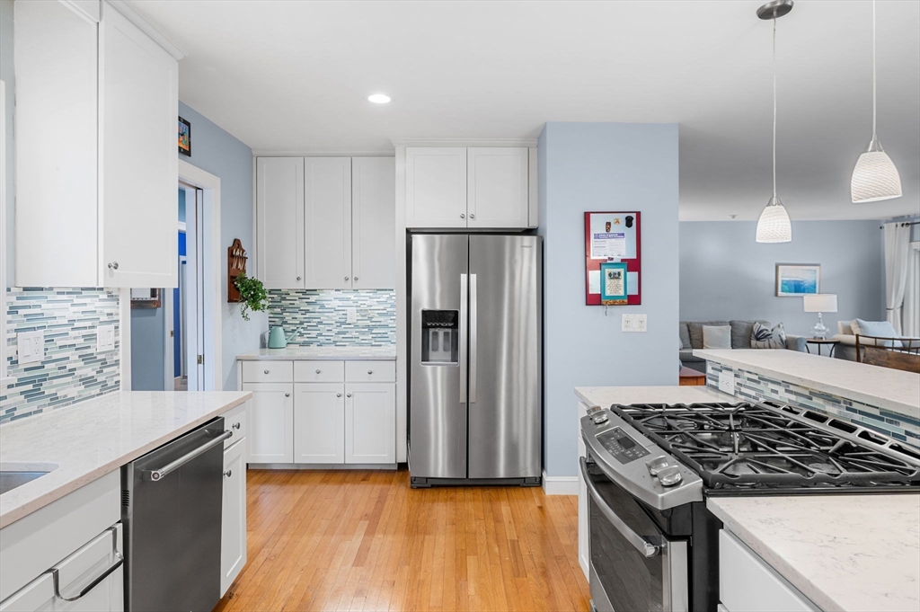 1 Court Lane Ipswich, MA 01938 - Photo 17 of 40 a kitchen with stainless steel appliances granite countertop a refrigerator stove and sink