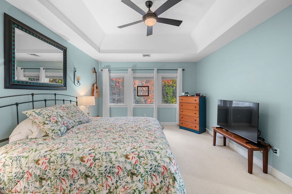 1 Court Lane Ipswich, MA 01938 - Photo 23 of 40 a bedroom with a bed a dresser and a chandelier