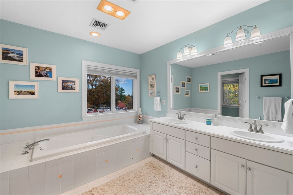1 Court Lane Ipswich, MA 01938 - Photo 25 of 40 a spacious bathroom with a tub sink and mirror