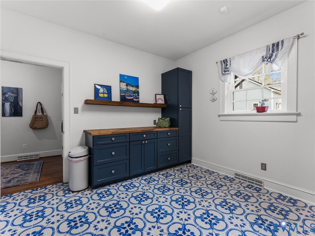 12522 Stagfield Road Ashland, VA 23005 - Photo 29 of 72 Laundry room with custom cabinetry and workspace.
