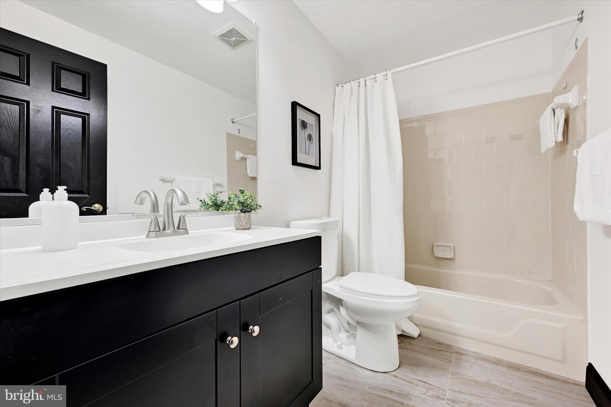 22 Rain Flower Path, Unit 301 Sparks Glencoe, MD 21152 - Photo 14 of 21 a bathroom with a sink a toilet and shower
