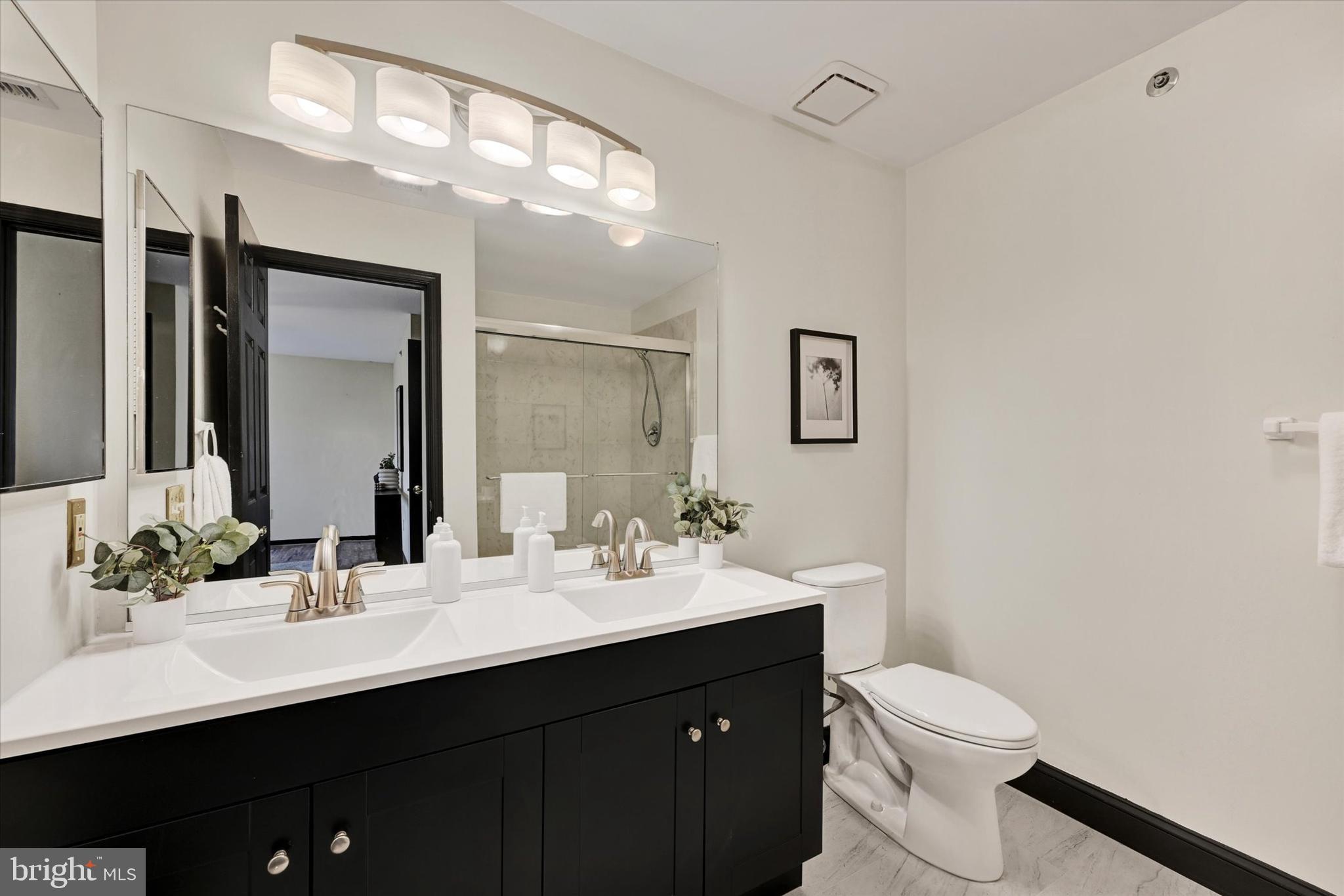 22 Rain Flower Path, Unit 301 Sparks Glencoe, MD 21152 - Photo 18 of 21 a bathroom with a sink and a mirror